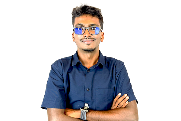 Young man with a navy shirt and glasses, arms crossed, looking at the camera against a white background.