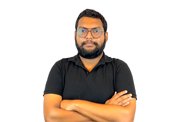 Man with a beard and glasses, wearing a black polo shirt, arms crossed, looking at the camera.